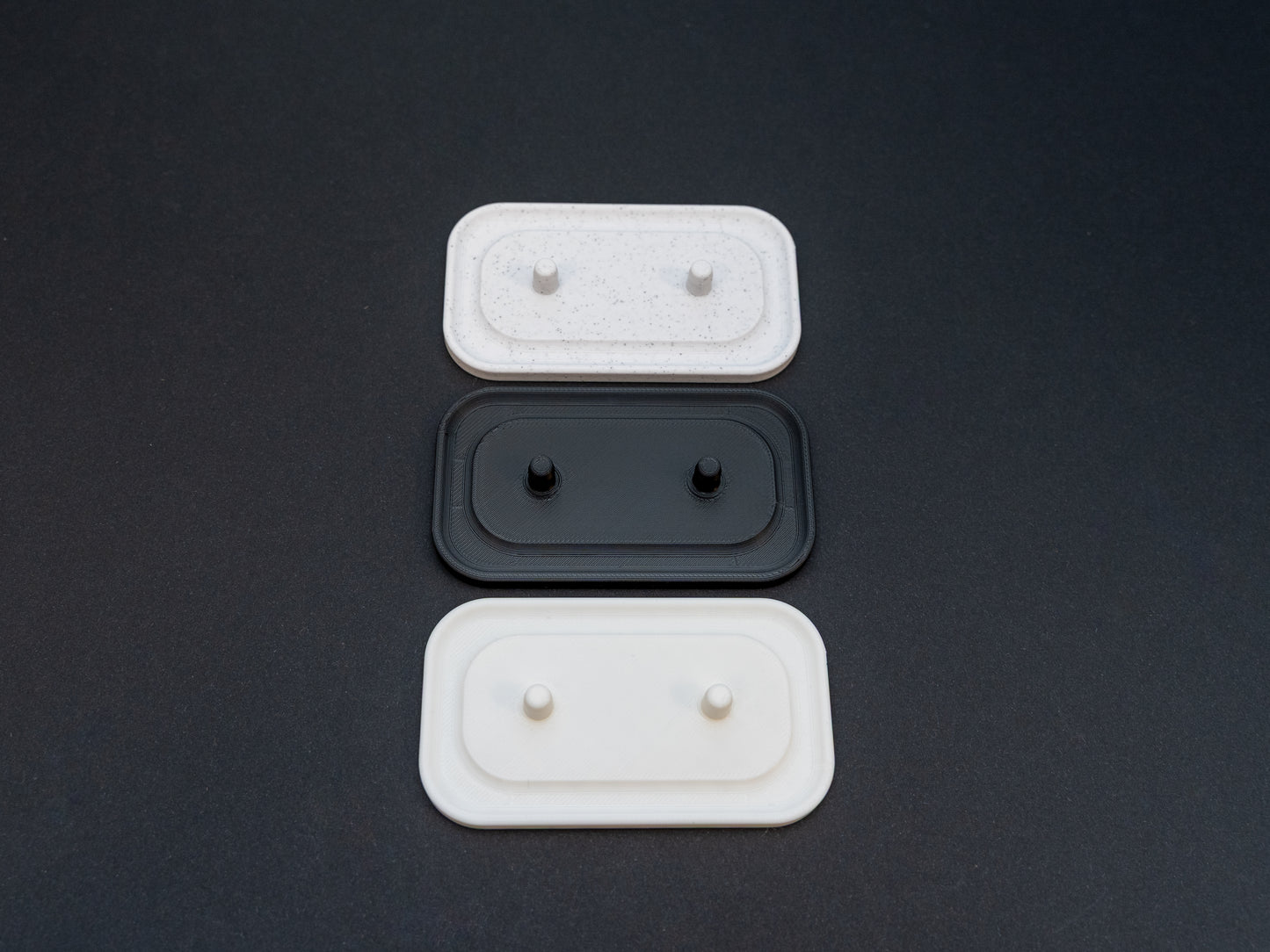 Philips Sonicare electric toothbrush stands that hold two toothbrushes shown in white, black and white stone effect.