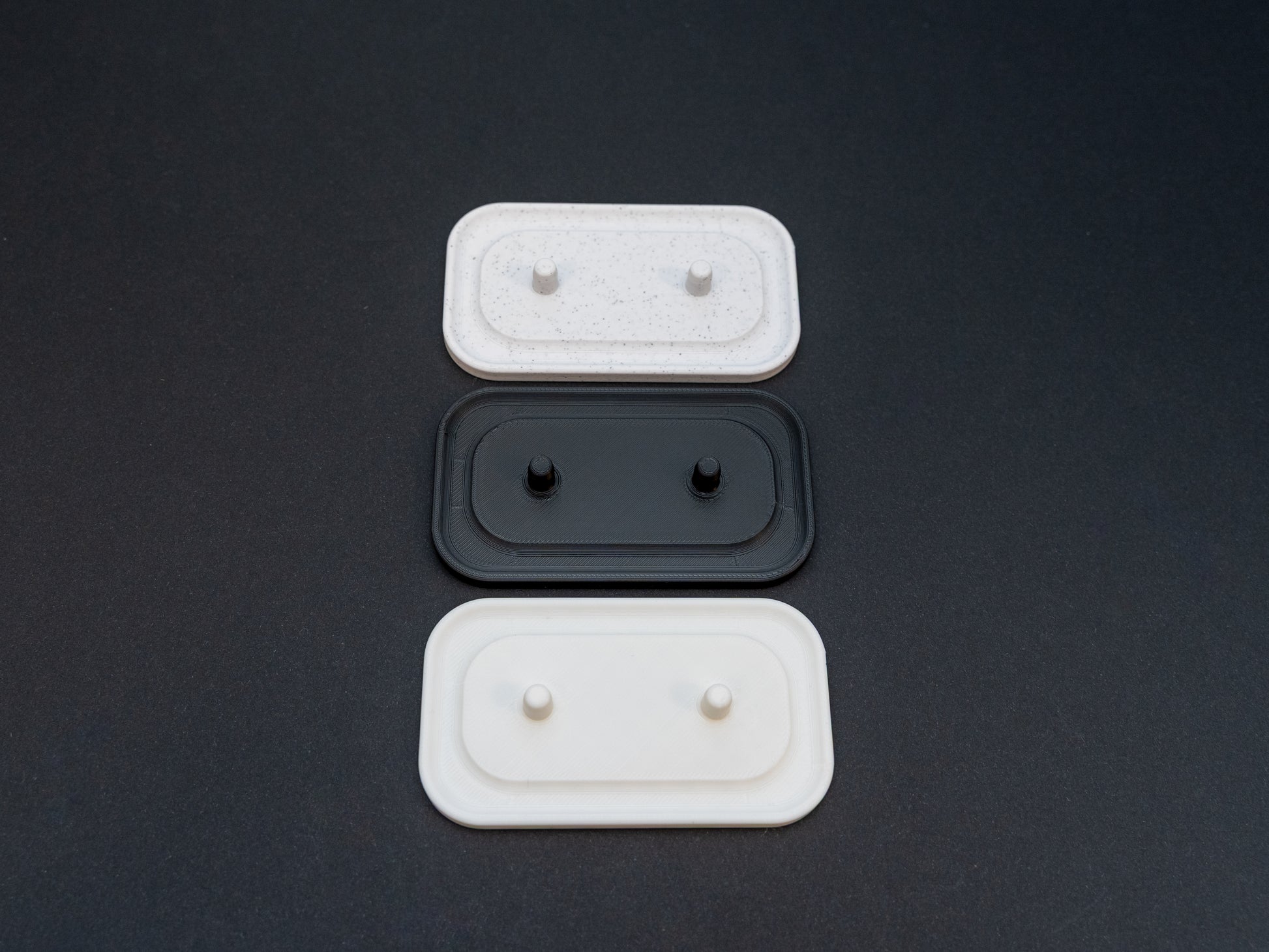 Philips Sonicare electric toothbrush stands that hold two toothbrushes shown in white, black and white stone effect.