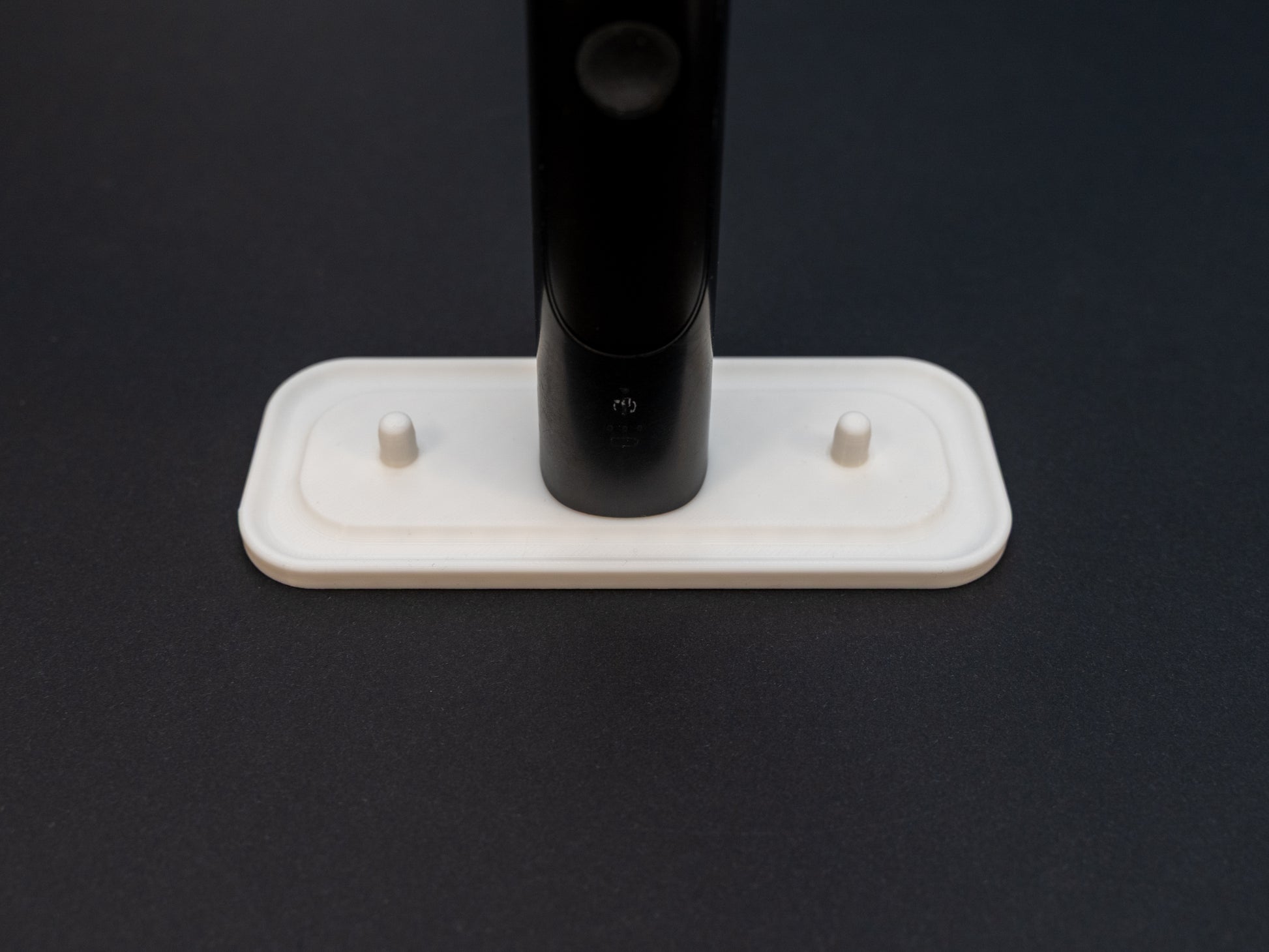 Philips Sonicare electric toothbrush stand that holds three toothbrushes shown in white.