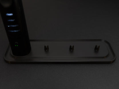 Philips Sonicare electric toothbrush stand that holds four toothbrushes shown in black.