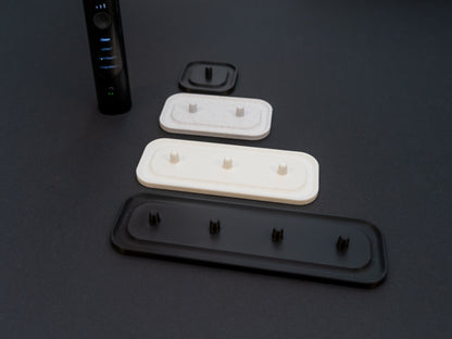 Philips Sonicare electric toothbrush stands that hold one, two, three or four toothbrushes shown in white stone effect, black and white.