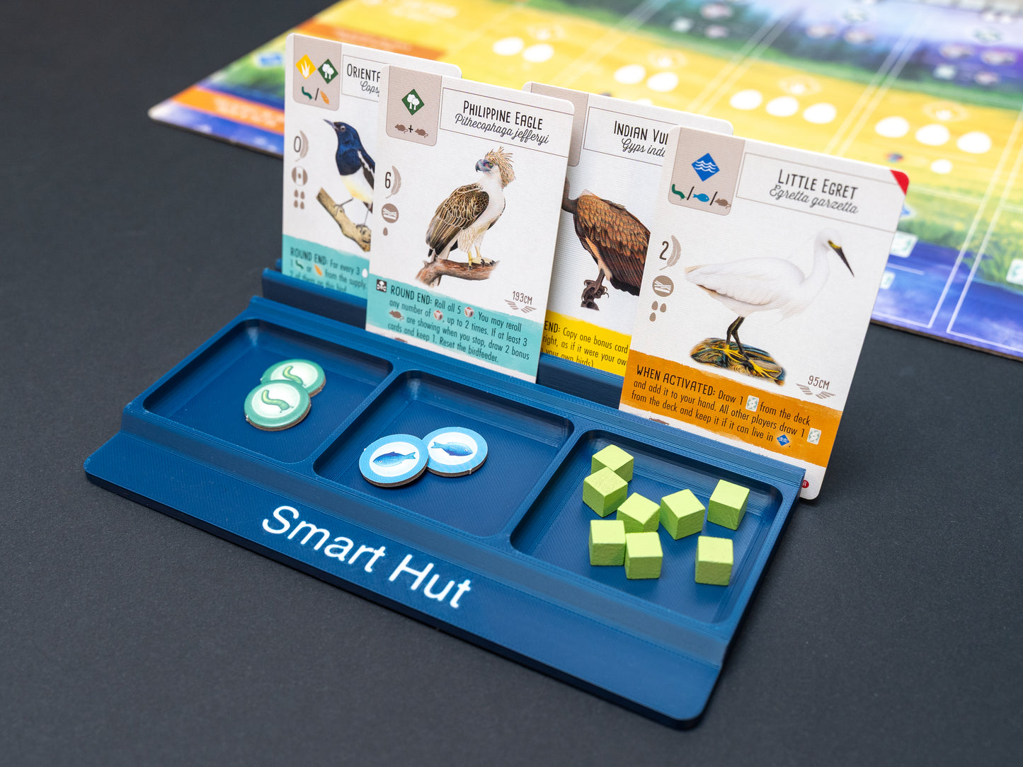 Navy blue board game card and token holder organiser with 2 rows for cards and 3 trays for tokens. Has space at the front for personalisation photo shows white text, Suitable for a range of board games such as Wingspan, Wyrmspan, Finspan and many more.