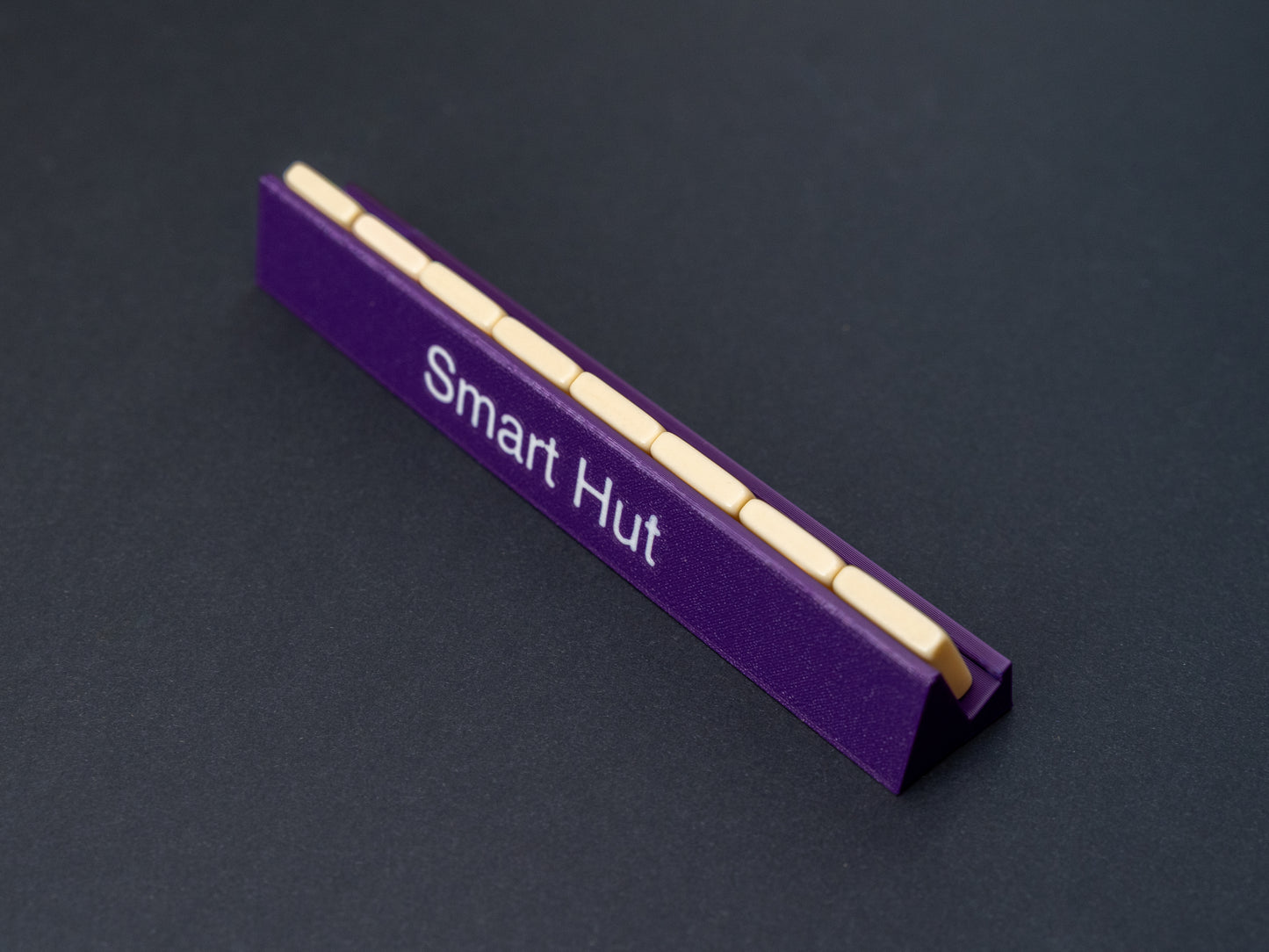 Personalised indigo purple scrabble and bananagrams tile holder. Shown with the personalisation in white text at the front and tiles in the tray at the back.