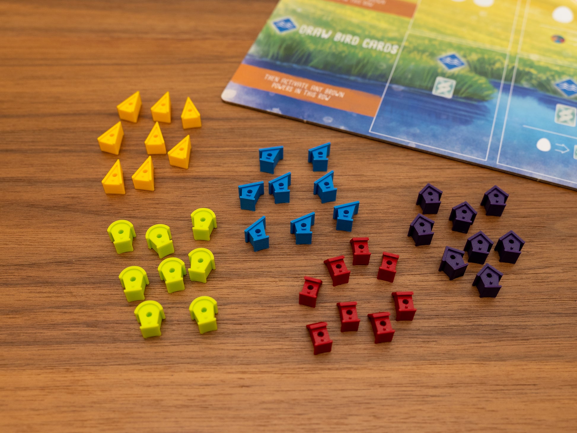 Wingspan bird houses are a player token upgrade for the wooden cubes that come with the original board game. Full set for 5 players in yellow, green, blue, red and purple.