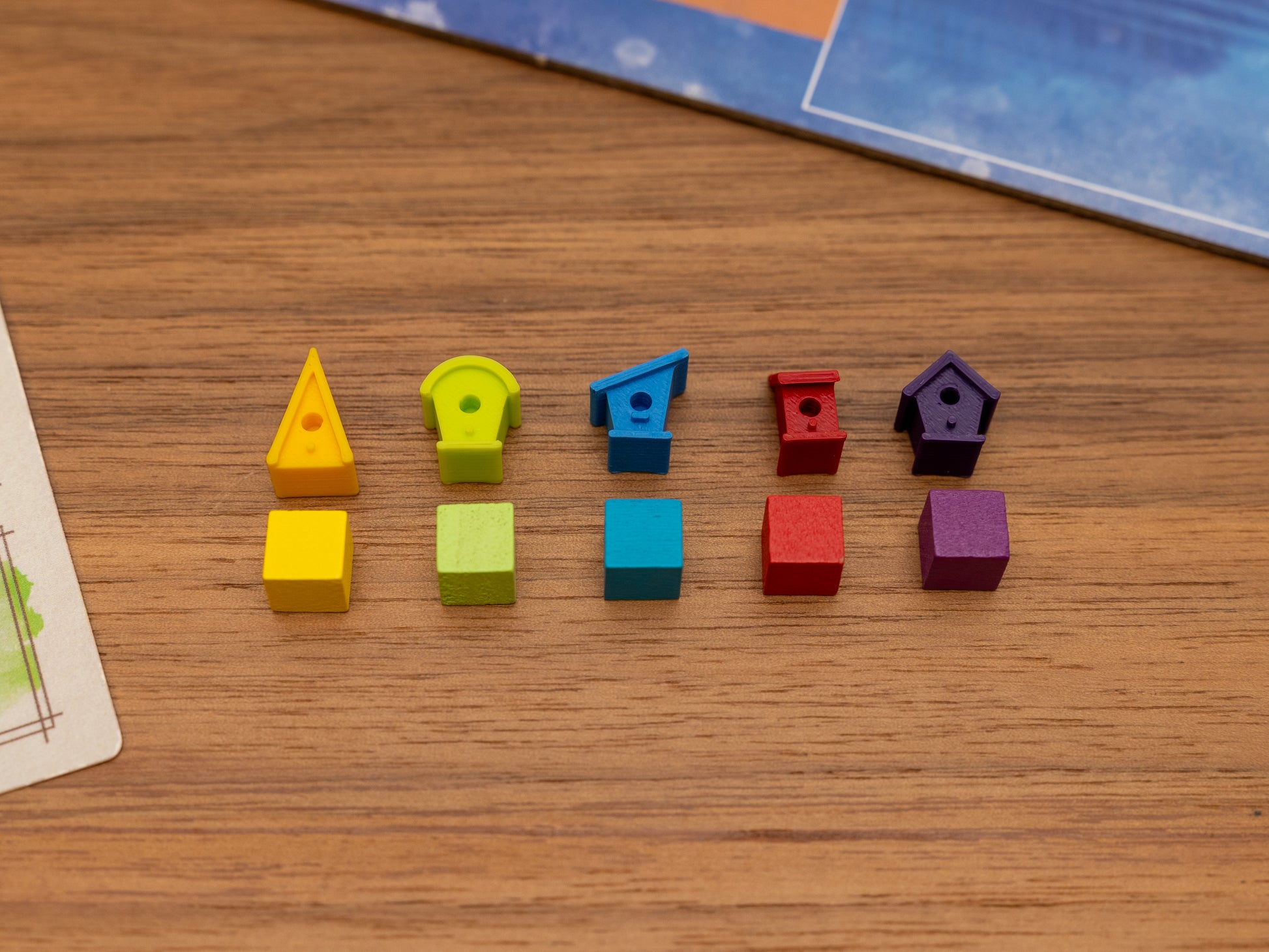 Wingspan bird houses are a player token upgrade for the wooden cubes that come with the original board game. Full set for 5 players in yellow, green, blue, red and purple.