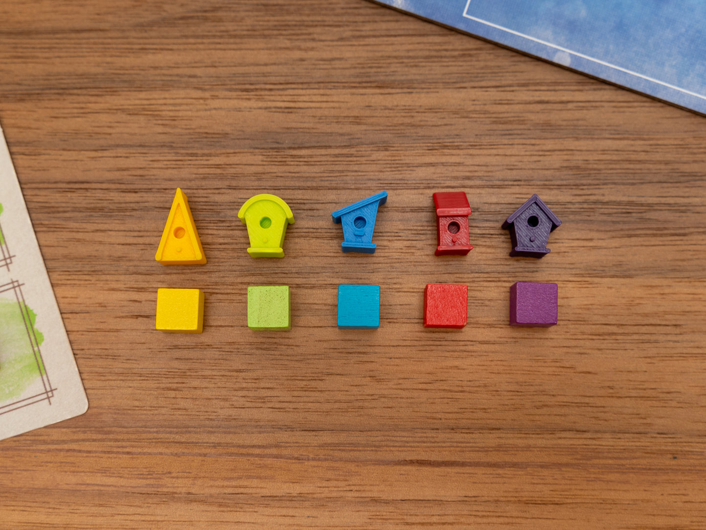 Wingspan bird houses are a player token upgrade for the wooden cubes that come with the original board game. Full set for 5 players in yellow, green, blue, red and purple.