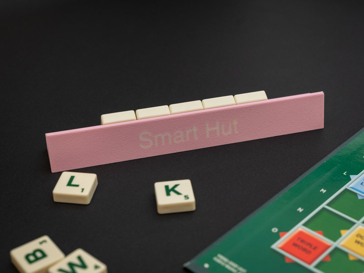 Personalised pink scrabble and bananagrams tile holder. Shown with the personalisation in white text at the front and tiles in the tray at the back.