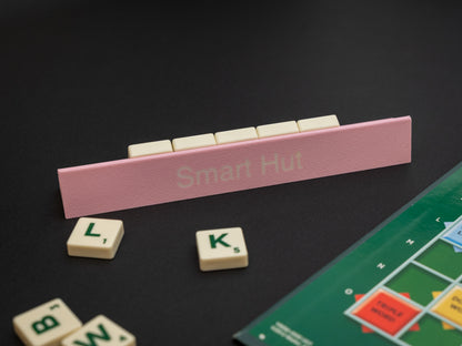 Personalised pink scrabble and bananagrams tile holder. Shown with the personalisation in white text at the front and tiles in the tray at the back.