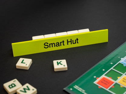 Personalised apple green scrabble and bananagrams tile holder. Shown with the personalisation in black text at the front and tiles in the tray at the back.