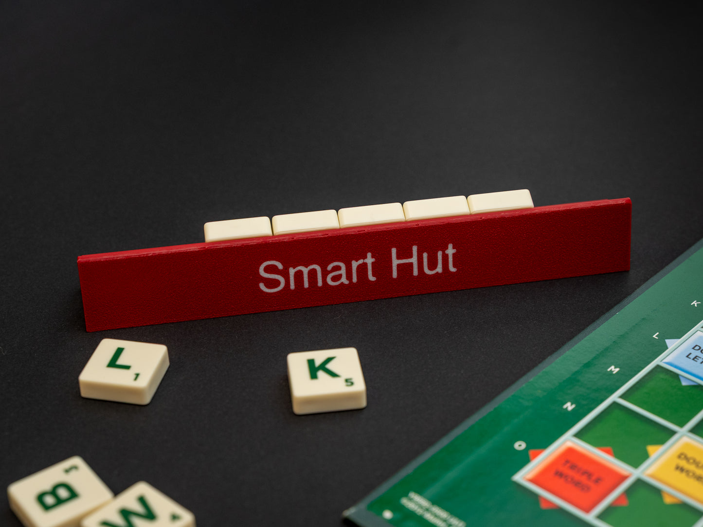 Personalised maroon red scrabble and bananagrams tile holder. Shown with the personalisation in white text at the front and tiles in the tray at the back.