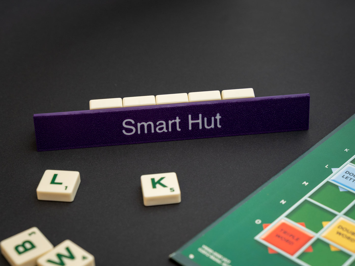 Personalised indigo purple scrabble and bananagrams tile holder. Shown with the personalisation in white text at the front and tiles in the tray at the back.