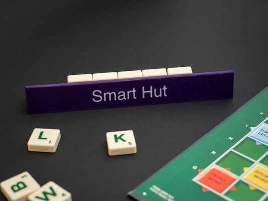 Personalised indigo purple scrabble and bananagrams tile holder. Shown with the personalisation in white text at the front and tiles in the tray at the back.